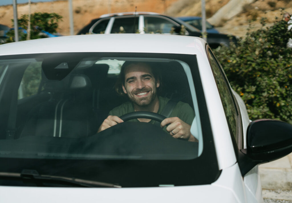 Caleb in the drivers seat of our car rental in Crete, Greece before taking off for our Crete road trip