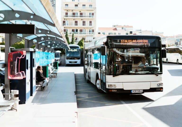 a local bus pulling up to the bus stop at the Chania Bust Station in Crete, Greece