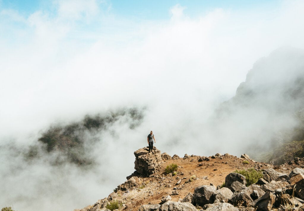 Caleb standing in the clouds at Pico Do Arieiro, one of the most famous hikes in Madeira. Definitely add this place to your itinerary during 4 days in Madeira!
