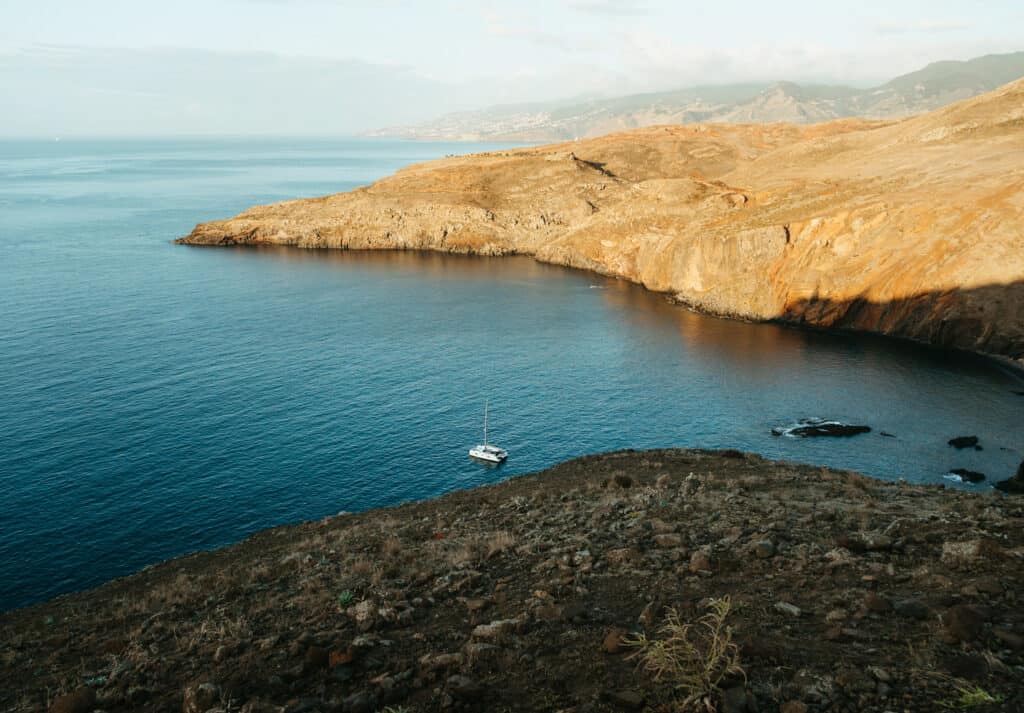 The Sao Lourenco Trail in Madeira. the sun is shining on the mountains creating a beautiful morning scene with the ocean down below