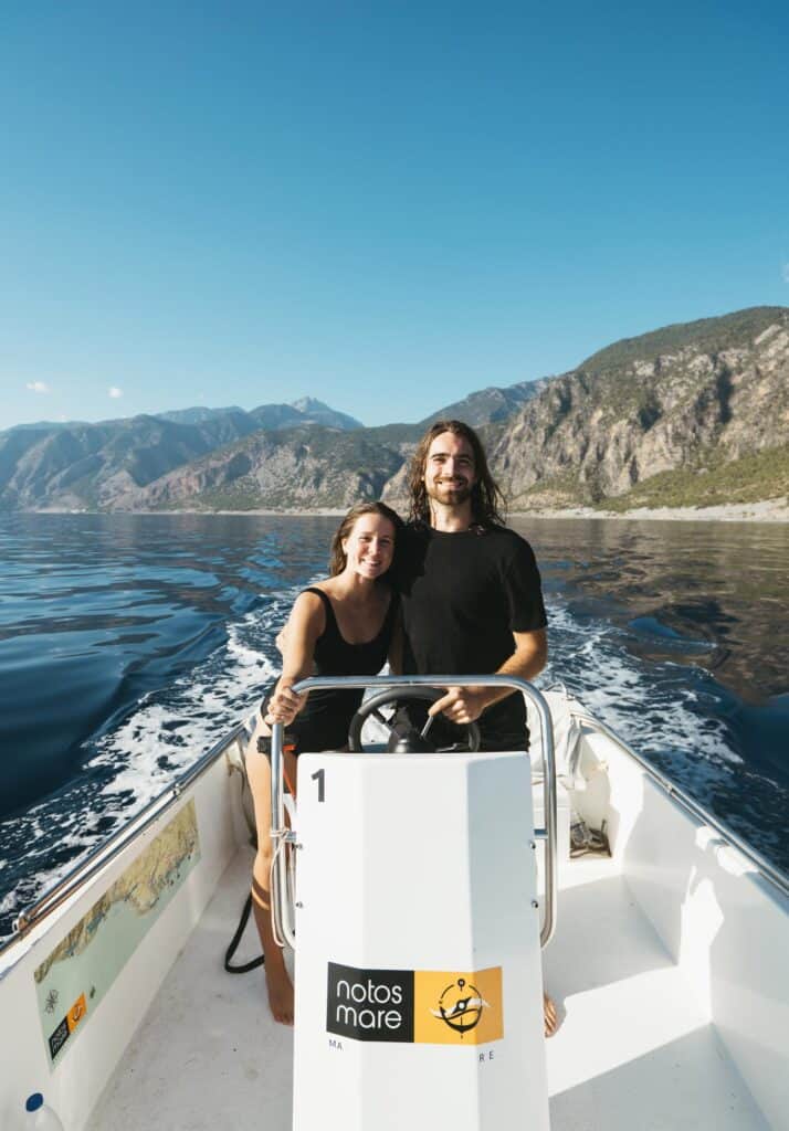 portrait of Calen and Sarah driving our boat rental in southern Crete, Greece