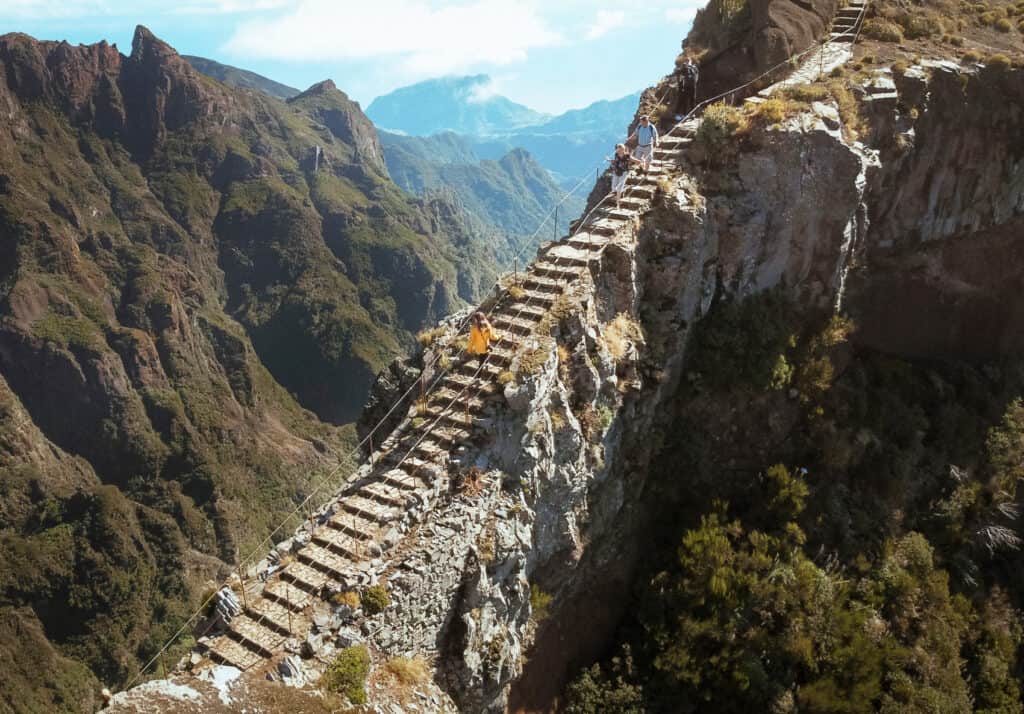 A drone view of Sarah climbing the famous stairway to heaven on the hike of Pico De Areerio, one of the best hikes in Madeira