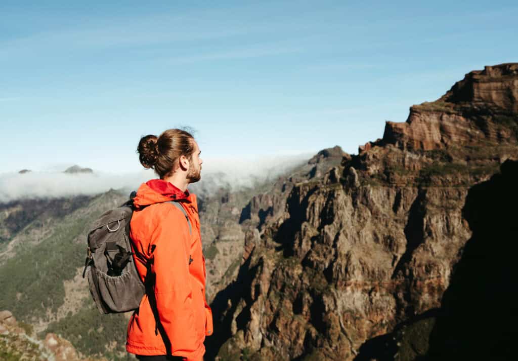 caleb staring off into the distance at Pico Do Ariero to Ruivio. You can see the stunning mountains in the distance