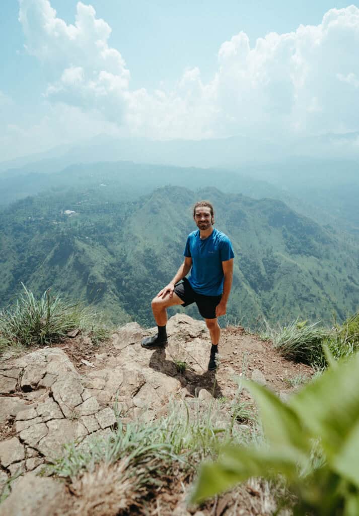 Caleb standing on a rocky ledge at Ella Rock in Sri Lanka.