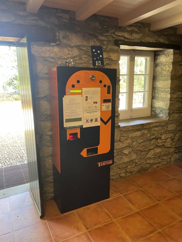 orange parking kiosk in a room at Queimadas–the entrance to Levada do Caldeirão Verde